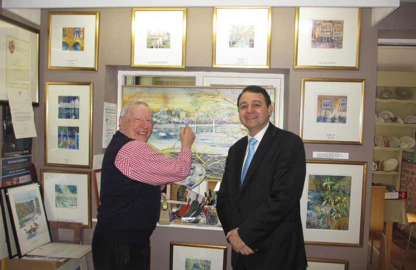 Alberto is pictured with Peter next to one of his paintings.